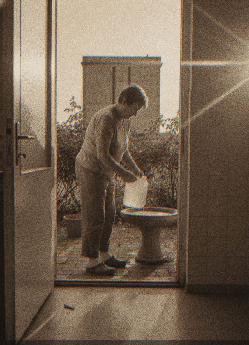 Siphoning Water for the Birdbath — photograph by Yuri Petrenko — MODULAR · 13 × 18 cm limited edition of 10